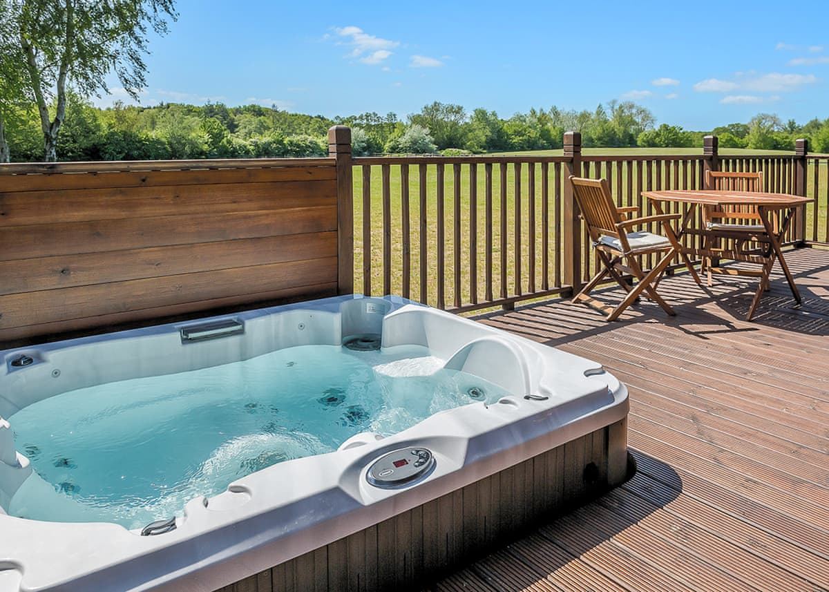 Lodge deck with private hot tub overlooking the meadow